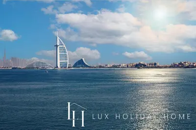 a large body of water with a building in the background at LUX The Anantara Residence Suite in Dubai