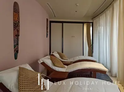 a bedroom with two beds and a window at LUX The Anantara Residence Suite in Dubai