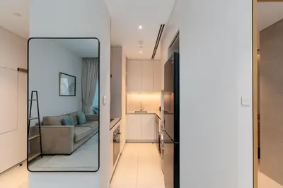 a room with a mirror and a living room with a couch at Address JBR Marina Views, Address Beach Resort Residence, Dubai Marina - Mint Stay in Dubai
