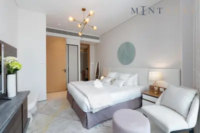 a bedroom with a king sized bed and a chair at Address JBR Marina Views, Address Beach Resort Residence, Dubai Marina - Mint Stay in Dubai