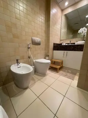 a bathroom with a sink and a toilet in it at Sunset Oasis: Beachfront Studio in Dubai