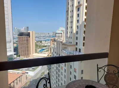 a view of a city from a balcony of a building at Sunset Oasis: Beachfront Studio in Dubai