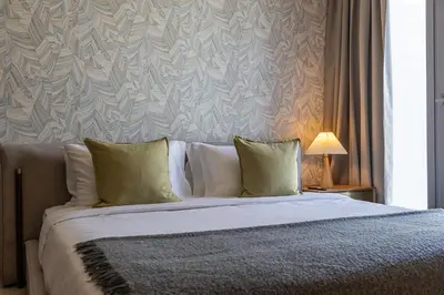 a bedroom with a large bed with green pillows at Spacious 3BDR Townhouse I Garden I Tilal Al ghaf in Dubai