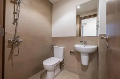 a bathroom with a toilet and a sink at Spacious 3BDR Townhouse I Garden I Tilal Al ghaf in Dubai