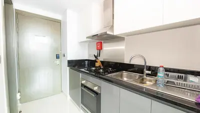 a kitchen with a sink and a counter top at Sleek Studio in Business Bay with Canal View Business Bay, Dubai in Dubai