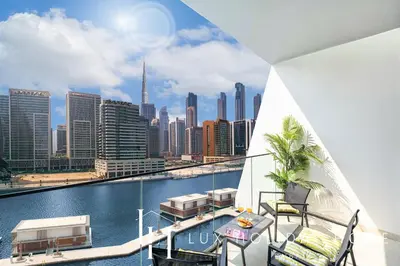 a view of the city from the balcony of a building at LUX The Modern Binghatti Canal Suite in Dubai