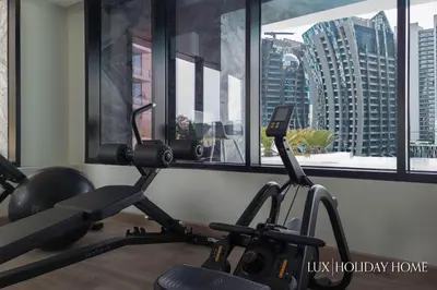 a gym with two exercise bikes in front of a window at LUX The Modern Binghatti Canal Suite in Dubai