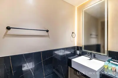 a bathroom with a sink and a mirror at LUX The Modern Binghatti Canal Suite in Dubai