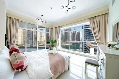 a bedroom with a bed and a large window at Charming 2BR + kid's room w/ Marina yacht view in Dubai
