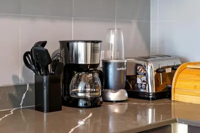 a kitchen counter with a blender and a toaster at Charming 2BR + kid's room w/ Marina yacht view in Dubai