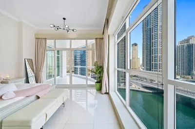 a living room with a view of the water at Charming 2BR + kid's room w/ Marina yacht view in Dubai