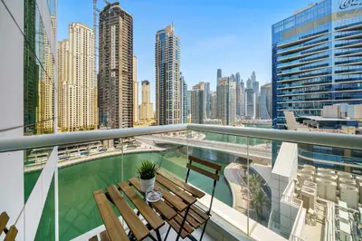 a balcony with benches and a view of a city at Charming 2BR + kid's room w/ Marina yacht view in Dubai
