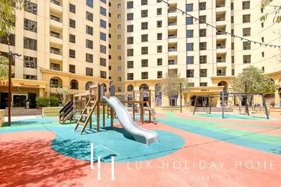a playground with a slide in front of a building at LUX The JBR Marina View Suite 2 in Dubai
