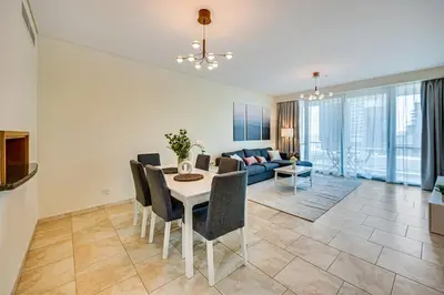a dining room and living room with a table and chairs at Huge fantastic 3 bedroom in Al Fattan Marine Tower in Dubai