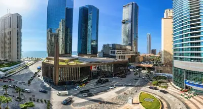 a city with tall buildings and a street with cars at Huge fantastic 3 bedroom in Al Fattan Marine Tower in Dubai
