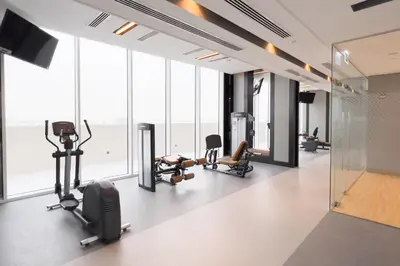 a gym with treadmills and exercise equipment in a building at GuestReady - A prime stay in Creek Harbour in Dubai