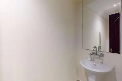 a white bathroom with a sink and a mirror at Souq Al Bahar - One Bed with Dubai Fountain View in Dubai