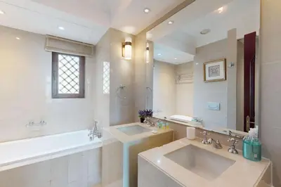 a large bathroom with a sink and a tub and a mirror at Souq Al Bahar - One Bed with Dubai Fountain View in Dubai