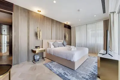 a bedroom with a large white bed and a television at FIVE Palm North Residences - Spectacular Three Bedroom in Dubai