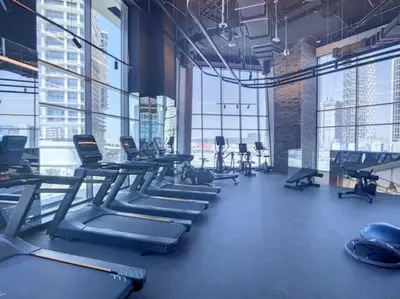 a gym with rows of exercise bikes and treadmills at 15 Northside Tower 2 - Charming One Bedroom in Dubai