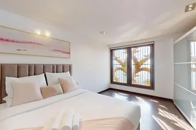 a bedroom with a large bed and a window at Bahar 1 - Opulent Three Bedroom in Dubai
