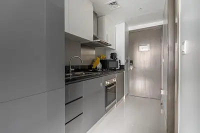 a kitchen with stainless steel cabinets and a sink at Frank Porter - DAMAC Prive in Dubai