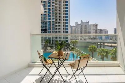 a balcony with a table and chairs and a large window at Frank Porter - DAMAC Prive in Dubai