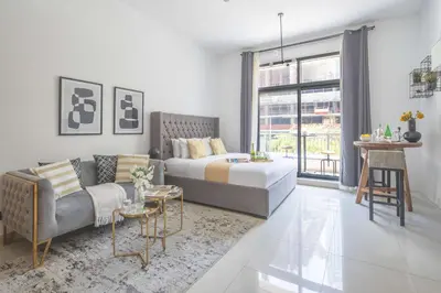 a living room with a bed and a couch at Frank Porter - Claren Tower in Dubai