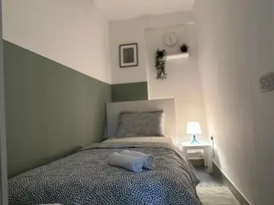 a bedroom with a bed with a white towel on it at Beautiful Partition Room in Al barsha 1 Near Metro in Dubai