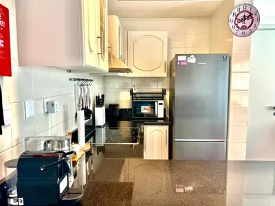 a kitchen with a stainless steel refrigerator and cabinets at The Waves 241 Dubai Marina in Dubai