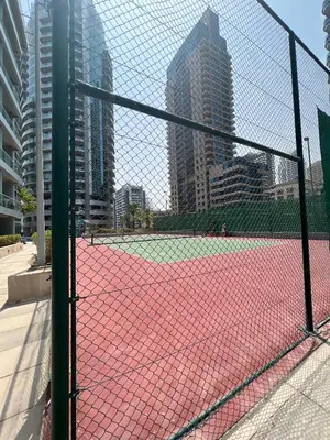a tennis court in the middle of a city at The Waves 241 Dubai Marina in Dubai