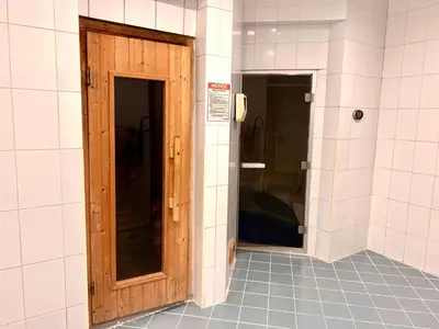a bathroom with a wooden door in a room at The Waves 241 Dubai Marina in Dubai