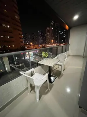 a balcony with a table and chairs on a building at SEASONING STAY AT DUBA MARINA in Dubai