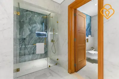 a shower with a glass door in a bathroom at Keysplease Upgraded 4 BR Beach Villa W Private Beach, Palm in Dubai