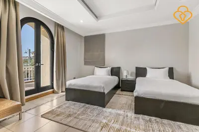 a bedroom with two beds and a large window at Keysplease Upgraded 4 BR Beach Villa W Private Beach, Palm in Dubai