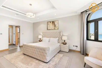 a white bedroom with a large bed and a window at Keysplease Upgraded 4 BR Beach Villa W Private Beach, Palm in Dubai