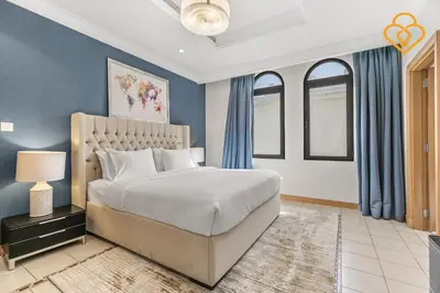 a bedroom with a large bed and blue walls at Keysplease Upgraded 4 BR Beach Villa W Private Beach, Palm in Dubai