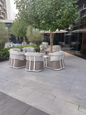 a group of chairs and an umbrella on a patio at Hotel Apartment Near Burj Khalifa - Opera T2 - شقة فندقية قريبة من برج خليفة اوبرا -برج 2 in Dubai