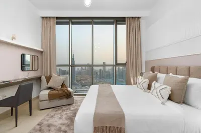 a bedroom with a large bed and a large window at Ultimate Stay Full Burj Khalifa & Downtown Views Designer Luxury High Floor connected to Dubai Mall for 4 People in Dubai