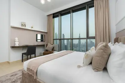a bedroom with a large bed with a large window at Ultimate Stay Full Burj Khalifa & Downtown Views Designer Luxury High Floor connected to Dubai Mall for 4 People in Dubai