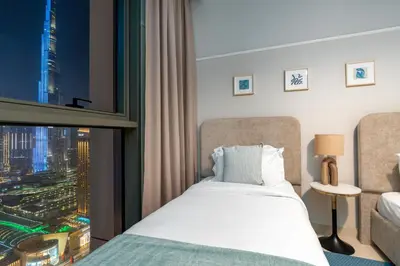 a bedroom with a bed and a large window at Ultimate Stay Full Burj Khalifa & Downtown Views Designer Luxury High Floor connected to Dubai Mall for 4 People in Dubai