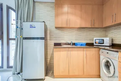 a kitchen with a refrigerator and a microwave at Near to Iconic Miracle & Butterfly Garden Urban Vibe Studio, Lincoln Park A, Arjan-Dubailand by Deluxe Holiday Homes in Dubai
