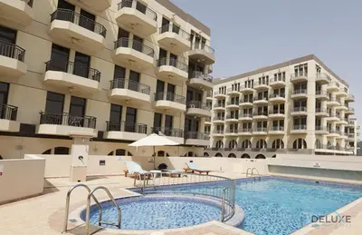 a swimming pool in front of a building at Near to Iconic Miracle & Butterfly Garden Urban Vibe Studio, Lincoln Park A, Arjan-Dubailand by Deluxe Holiday Homes in Dubai
