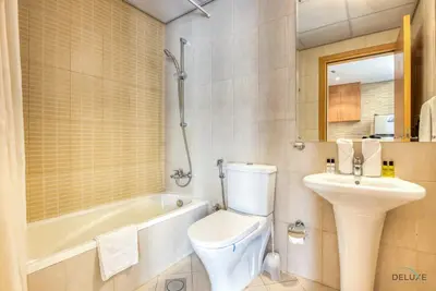 a bathroom with a toilet and a sink and a bath tub at Near to Iconic Miracle & Butterfly Garden Urban Vibe Studio, Lincoln Park A, Arjan-Dubailand by Deluxe Holiday Homes in Dubai