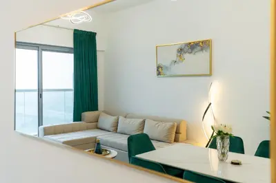a living room with a couch and a table at The Elite Apartment in Dubai