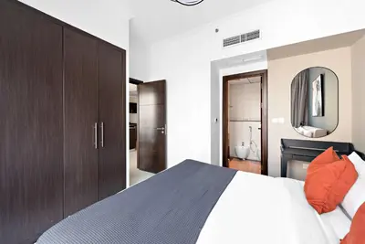 a bedroom with a large bed and a mirror at Silkhaus in Bay Central Near Metro in Dubai