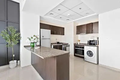 a kitchen with a counter and a dishwasher at Silkhaus in Bay Central Near Metro in Dubai