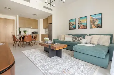 a living room with a blue couch and a table at Frank Porter - Summer at Creek Beach in Dubai