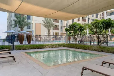 a swimming pool in the middle of a courtyard at Frank Porter - Summer at Creek Beach in Dubai