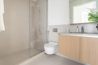 a bathroom with a shower and a toilet and a sink at Frank Porter - Summer at Creek Beach in Dubai